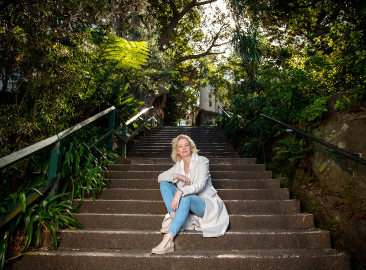 a woman sitting on garden stairs