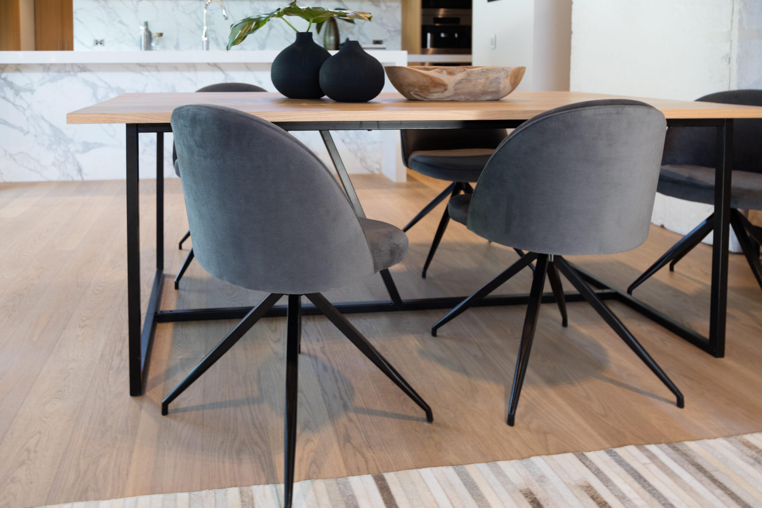 Stylish dining area featuring modern chairs and a wooden table, ideal for showcasing product launch photography Sydney.